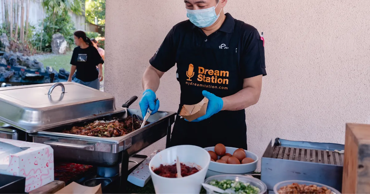 Dream Station staff managing a live food station at an event