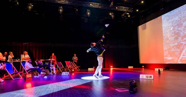 Paper airplane flying challenge at a dinner and dance