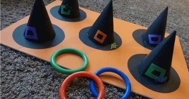 People is playing Witch hat ring toss at a Halloween party