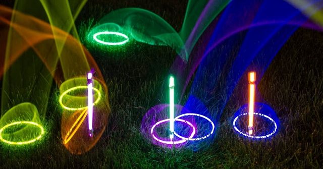 People is playing glow stick ring toss at a Halloween party