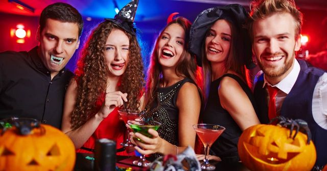 Halloween party attendees emerge themselves in the party theme