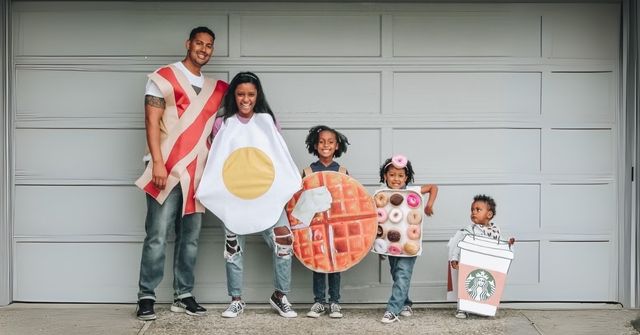 A family of 5 is taking a group photos with their DIY costumes on