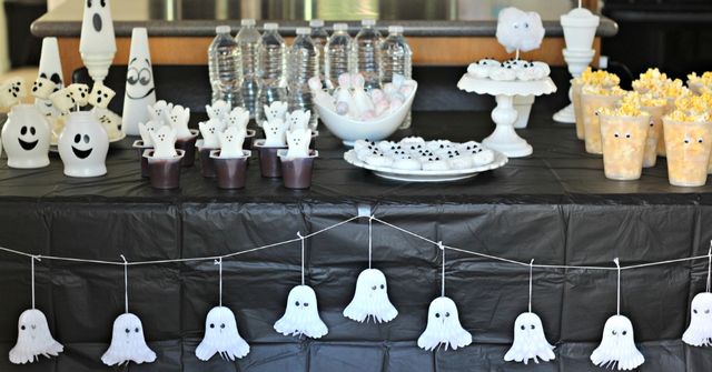 A desert table decorated with cute ghost inspired decorations