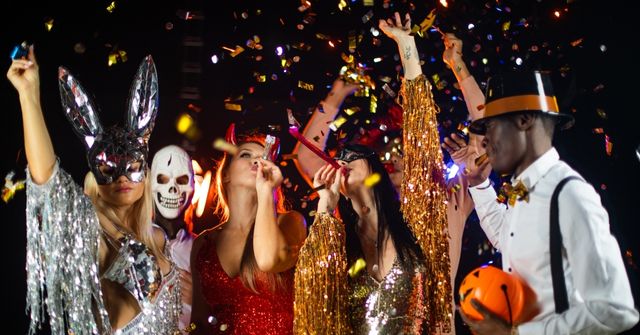 A group of participants dance to music at a Halloween party