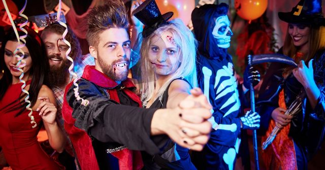 Participants at a Halloween party with their costumes on