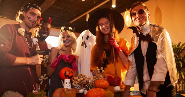 A group of Halloween party participants posing for photos