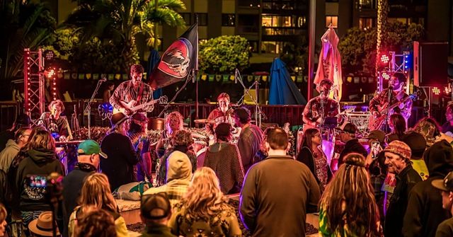 An overview of a Halloween party, taking place at a waterfront venue
