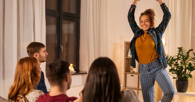 A female participant is describing the keyword to other people in the Thanksgiving Charades game