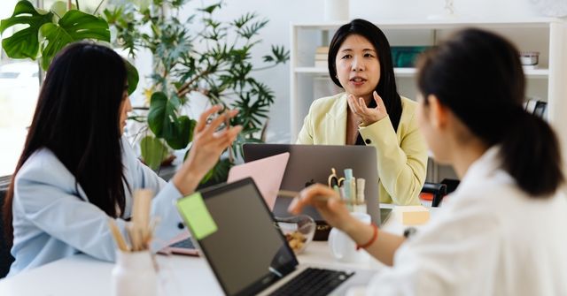 3 event planners in a meeting to plan for a company Christmas party
