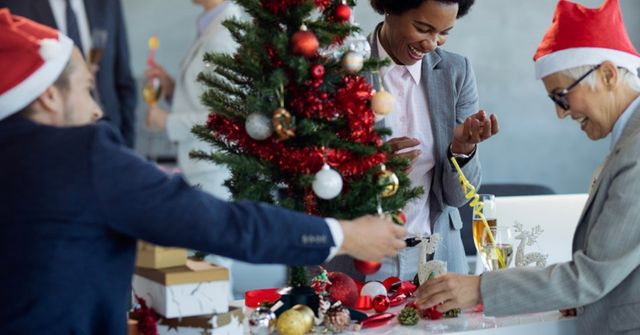 Employess participate in an Christmas tree decorating contest