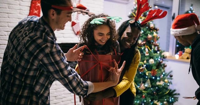 A group of colleagues celebrate Christmas Wrap-a-Teammate challenge