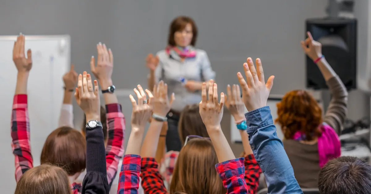 A speaker performs Raise Your Hand as a conference icebreaker