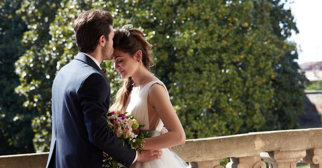 A bride and groom embrace tenderly on a sunlit venue sorted by our wedding planner team