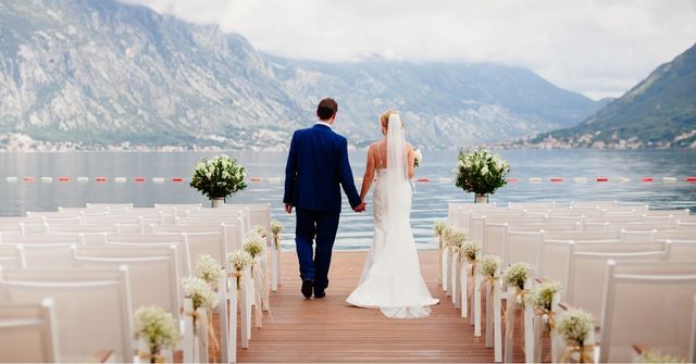 Bride and groom walking down an aisle at a wedding managed by our wedding planner team
