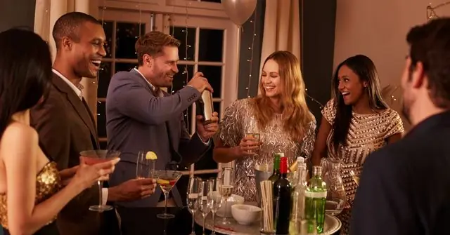 A group of six colleagues in polished and professional work Christmas party outfits 