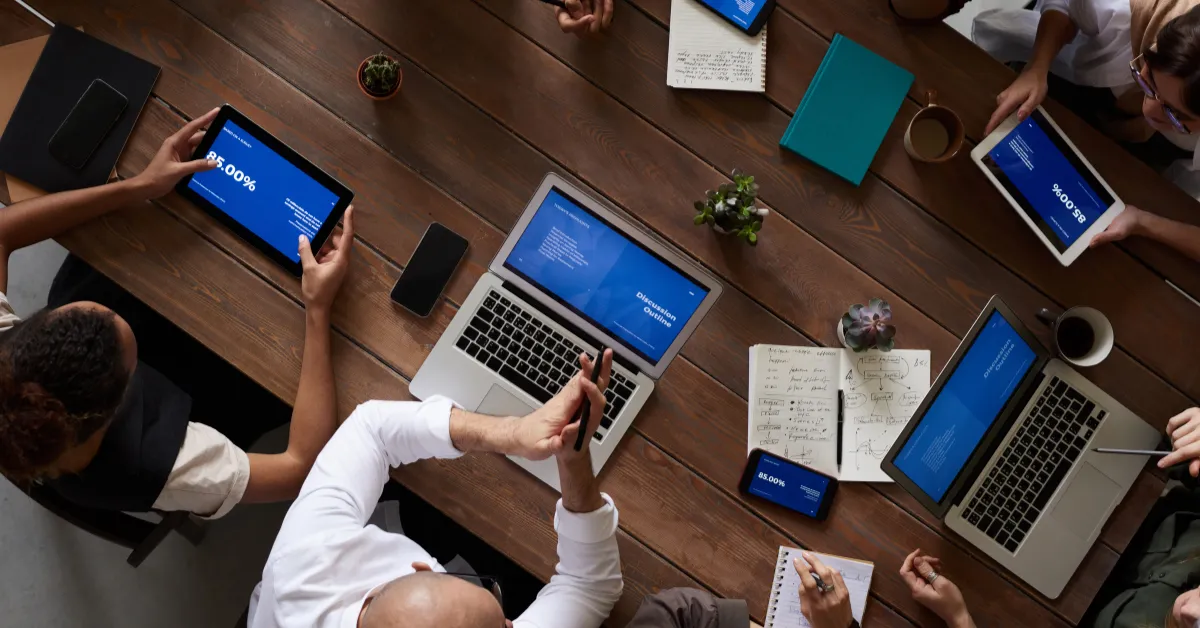 Overhead view of a collaborative meeting with diverse stakeholders on their seminar planning