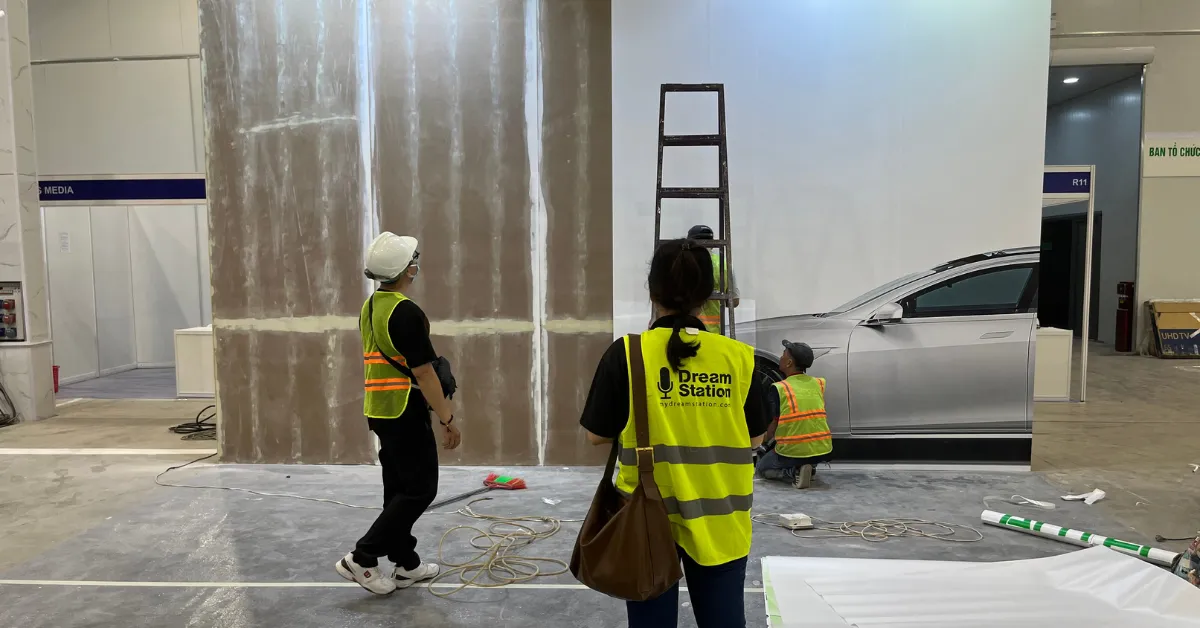 Dream Station staff during an on-site installation of a client's booth