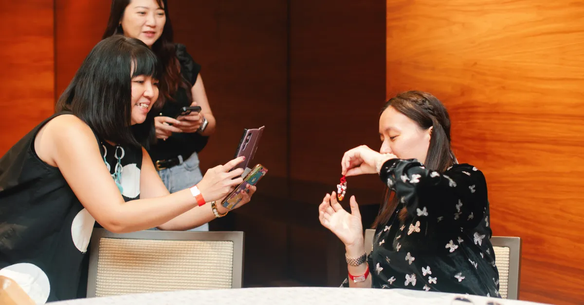 Event attendees happily taking photos with their DIY keychains