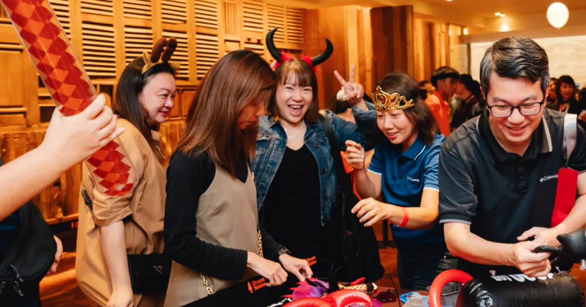 A group of event attendees happily taking part in a photobooth fringe activity